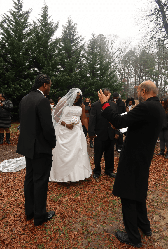 A man is taking a picture of a bride and groom