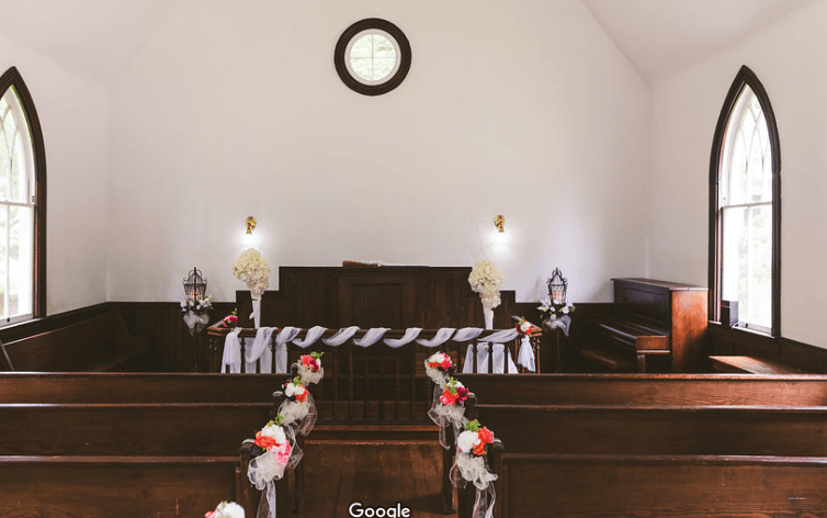 There is a clock on the wall above the altar in the church.