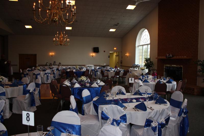A large room with tables and chairs set up for a wedding reception with a table number 8