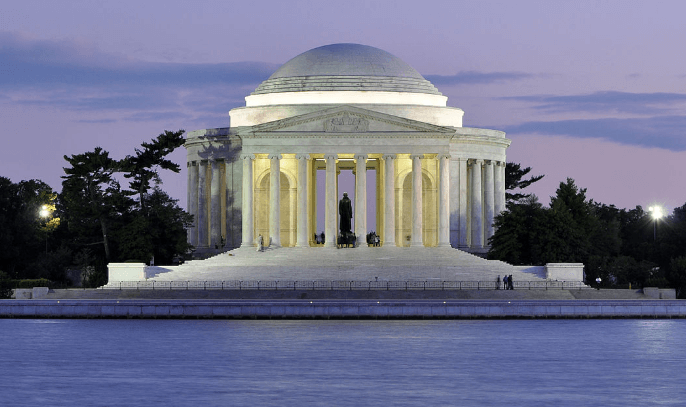 The washington monument is lit up at night in washington d.c.