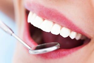 Woman Teeth And A Dentist Mouth Mirror - General Dentistry in Schererville, IN Woman Teeth And A Dentist Mouth Mirror - General Dentistry in Schererville, IN