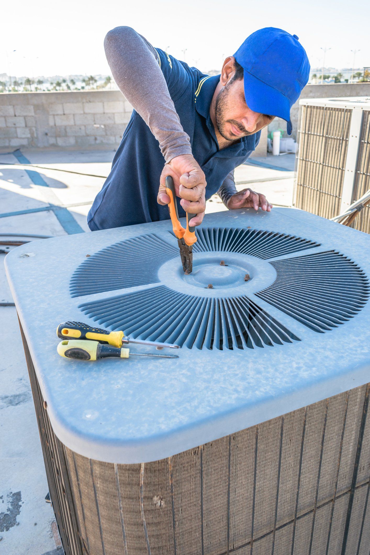 Technician Repairing Air Conditioner — Buhler, KS — Reimer Refrigeration Technician Repairing Air Conditioner — Buhler, KS — Reimer Refrigeration