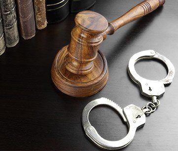 Jail Release — Judges Gavel, Handcuffs and Old Book on the Black Table in Panama City, FL Jail Release — Judges Gavel, Handcuffs and Old Book on the Black Table in Panama City, FL