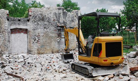 digger demolishing a building
