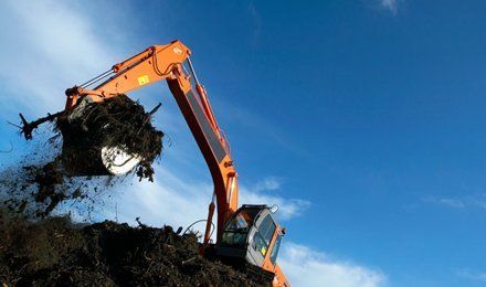 digger picking up rubbish