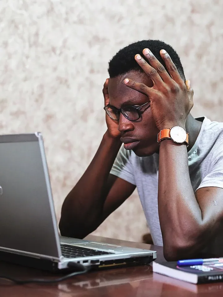 man at laptop looking stressed