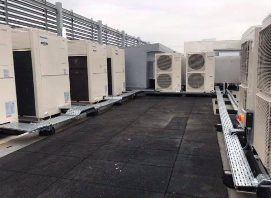 large air conditioners outside on roof top of a building