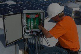 Electrical Engineer Among Solar Panels at Solar Power Plant - Electrical Maintenance in Cheyenne, WY Electrical Engineer Among Solar Panels at Solar Power Plant - Electrical Maintenance in Cheyenne, WY