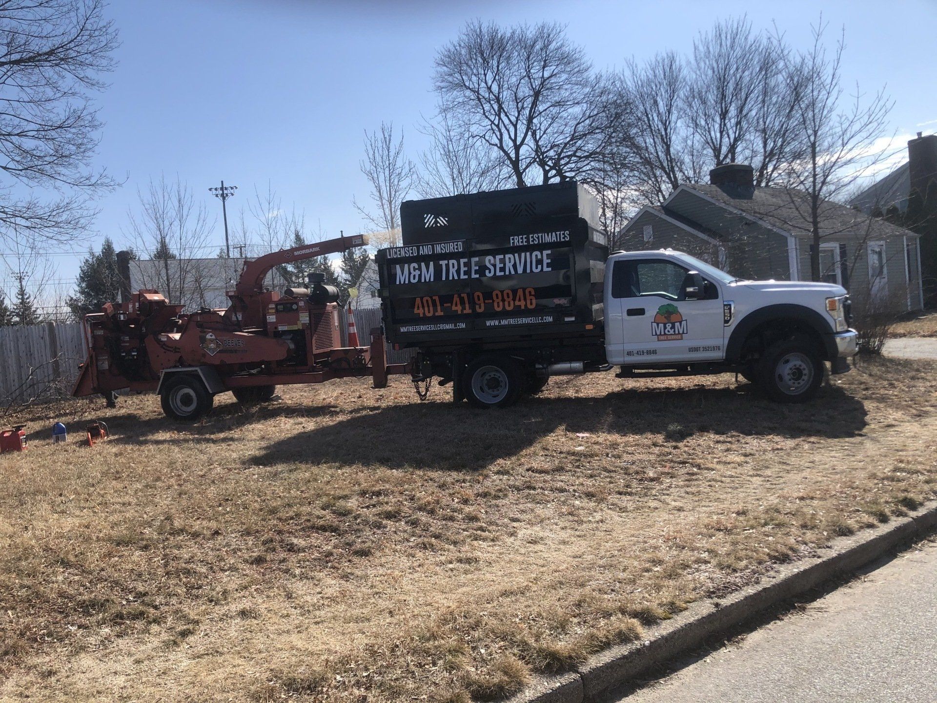 M&M Tree service truck at a work site