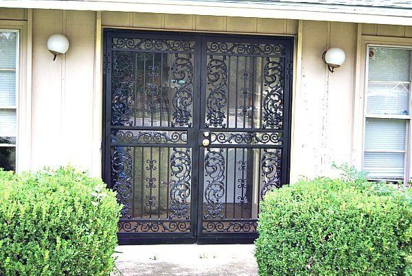 the front door of a house with a wrought iron gate