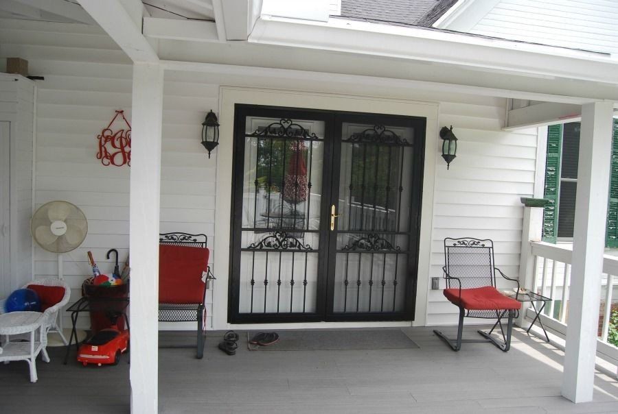 a porch with two rocking chairs and a fan