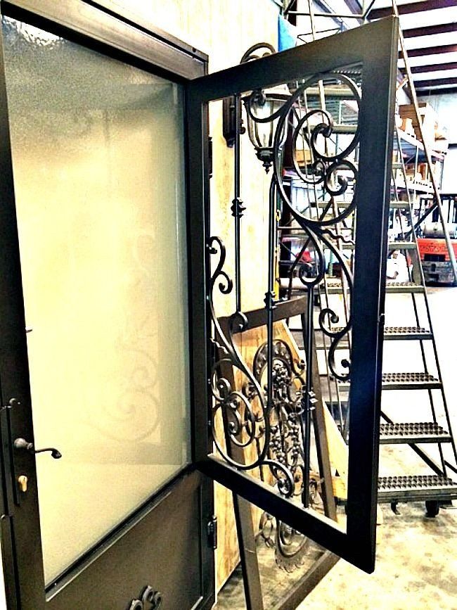a wrought iron door with a glass door and a ladder in the background .