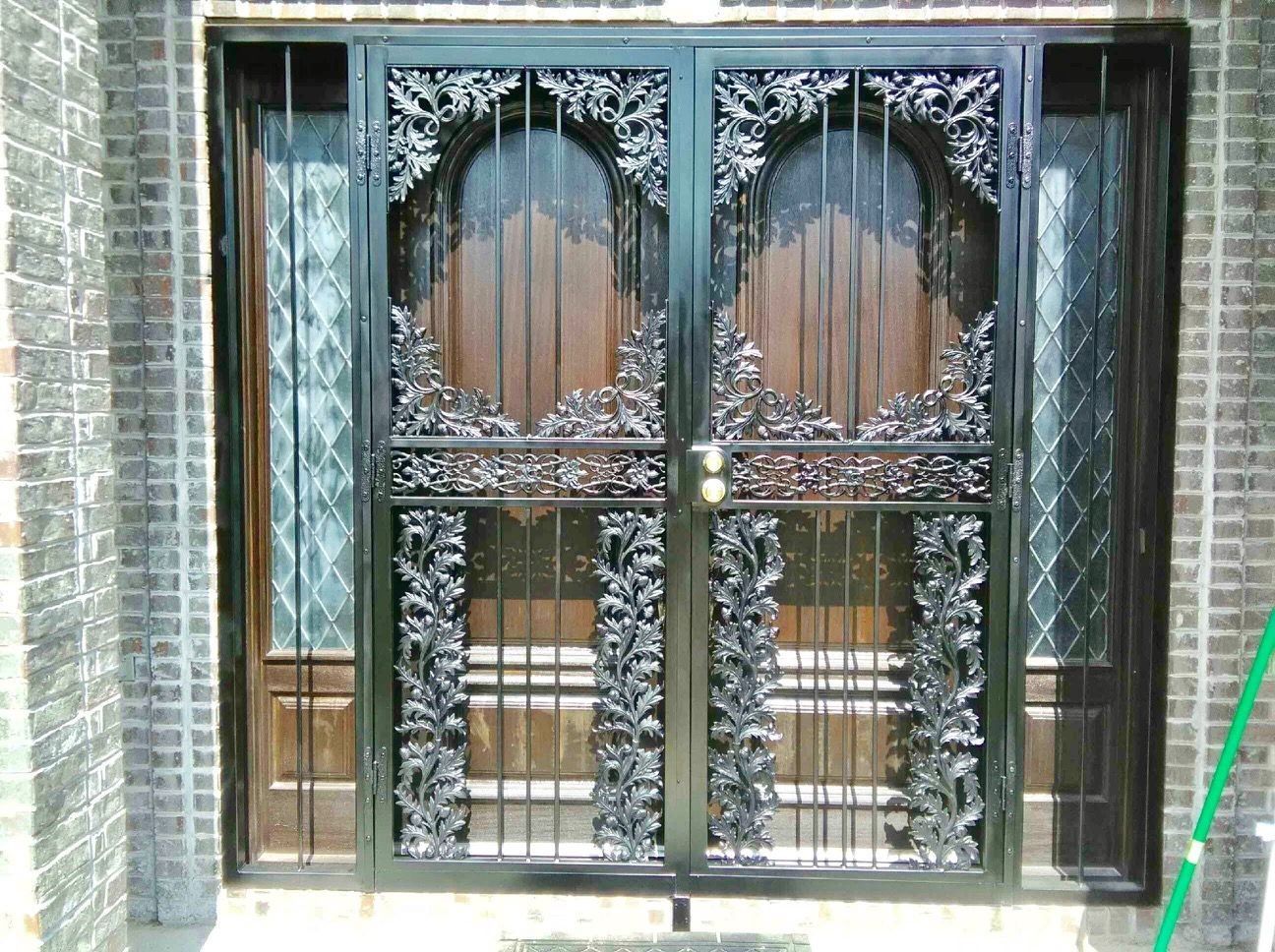 a wrought iron door with a green hose in front of itfrench