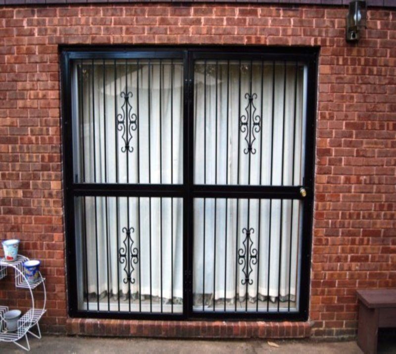 a window with a wrought iron gate on it