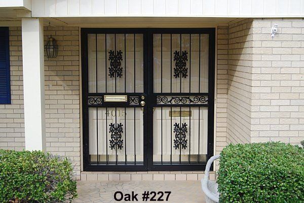 a brick building with a wrought iron gate that says oak # 227