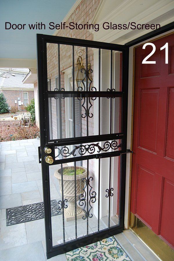 a red door with a black gate and the number 21 on it