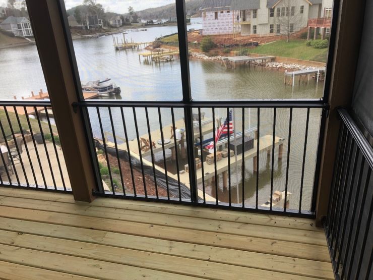 a screened in porch with a view of a body of water