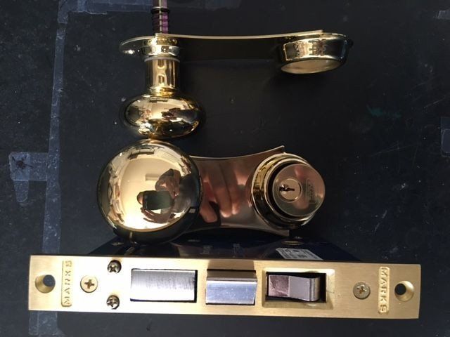 a brass door lock with a handle and a key