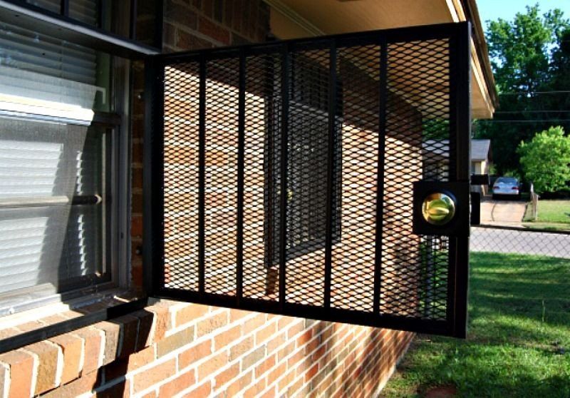 a brick building with a metal gate on the side of it
