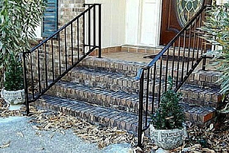 there is a wrought iron railing on the steps of a house .