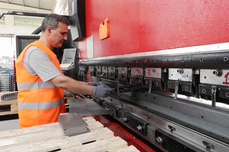 worker molding metal in factory