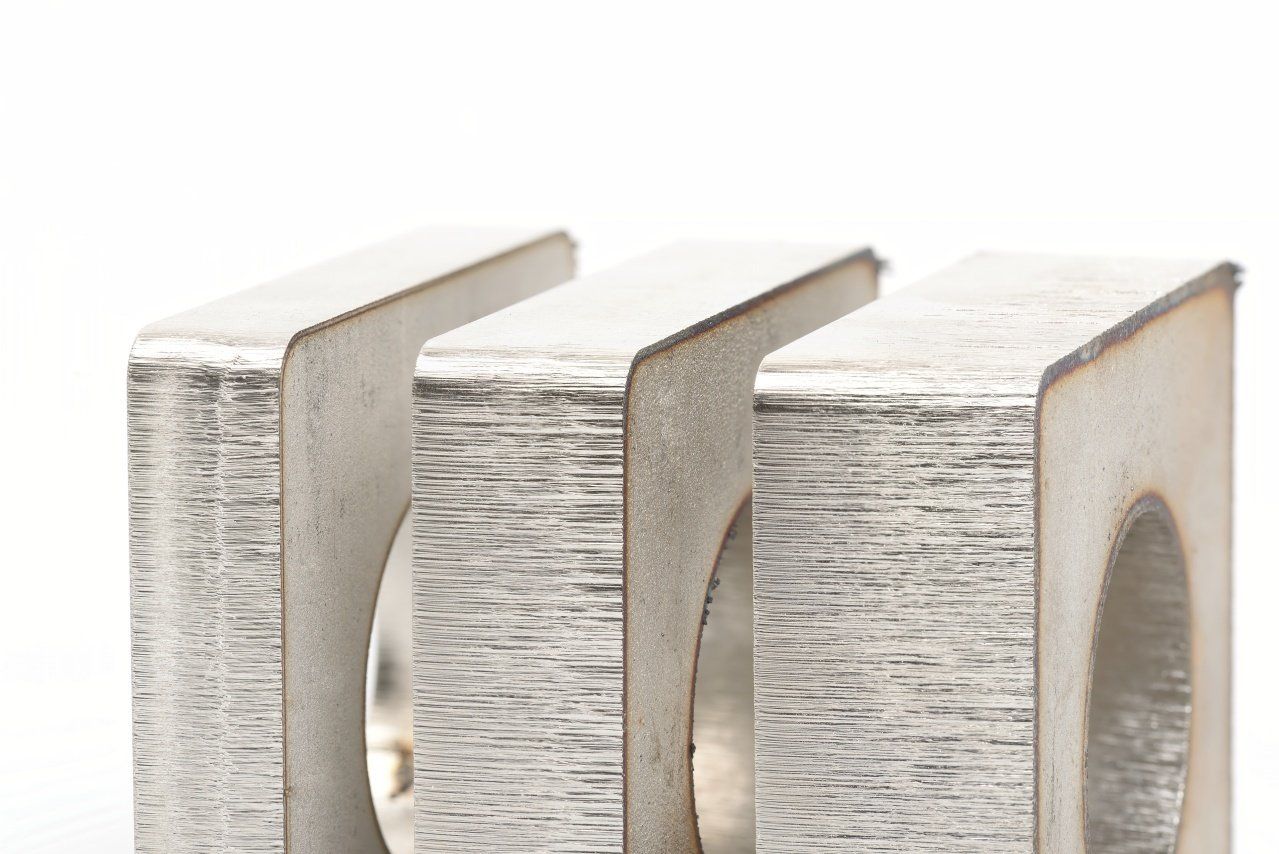 Close-up of a metal electrical component with three rectangular sections separated by vertical gaps. 