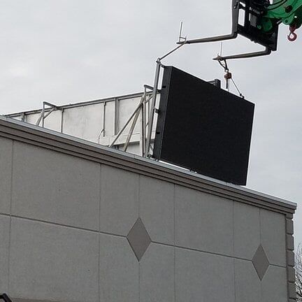 Attaching sign above building — sign company in Albany, NY