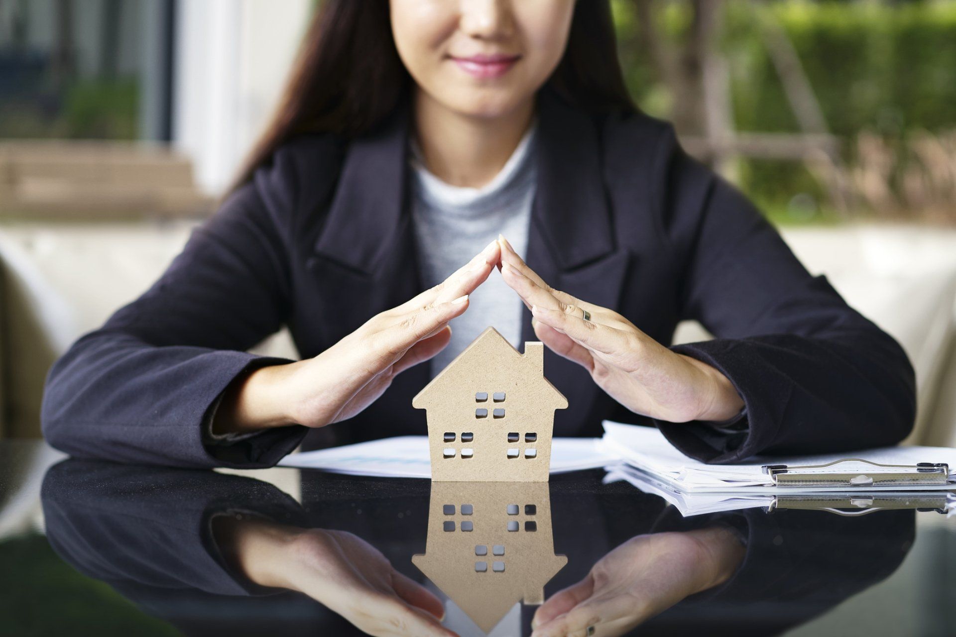 Woman Insurance Agent with House Miniature — Michigan City, IN — Snyder Insurance Agency Woman Insurance Agent with House Miniature — Michigan City, IN — Snyder Insurance Agency
