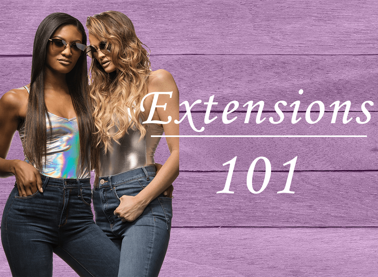 Two women are standing next to each other in front of a sign that says extensions 101.