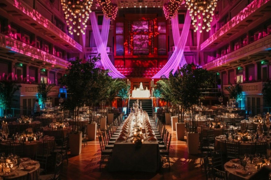 a large room filled with tables and chairs and a long table