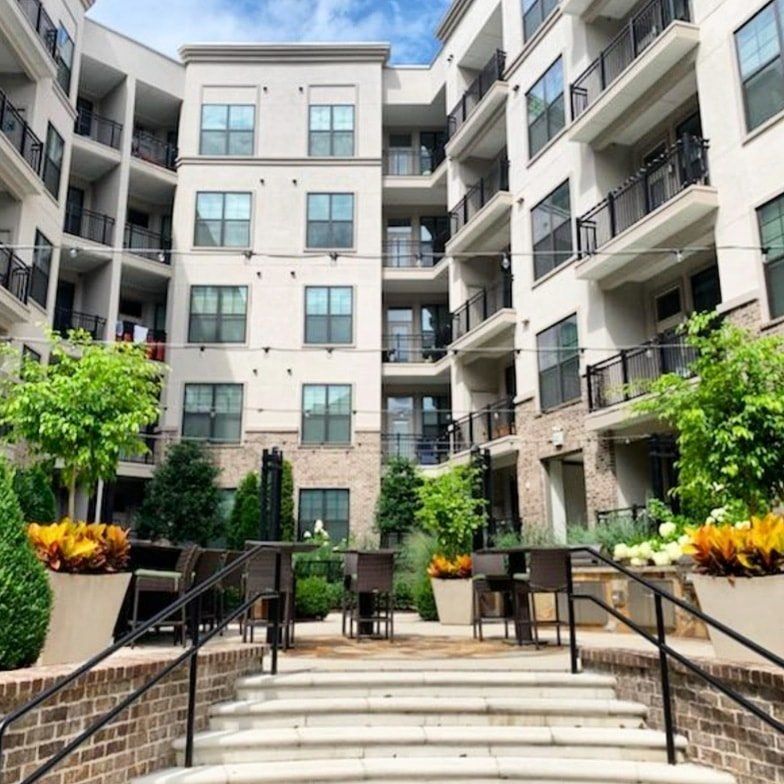 a large apartment building with stairs leading up to it
