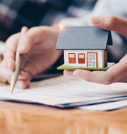Agent Holding a Model House — Staples, MN — Orth Insurance Agency Agent Holding a Model House — Staples, MN — Orth Insurance Agency