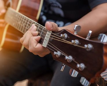 Guitar String — Man Playing Guitar  in Carlisle, PA