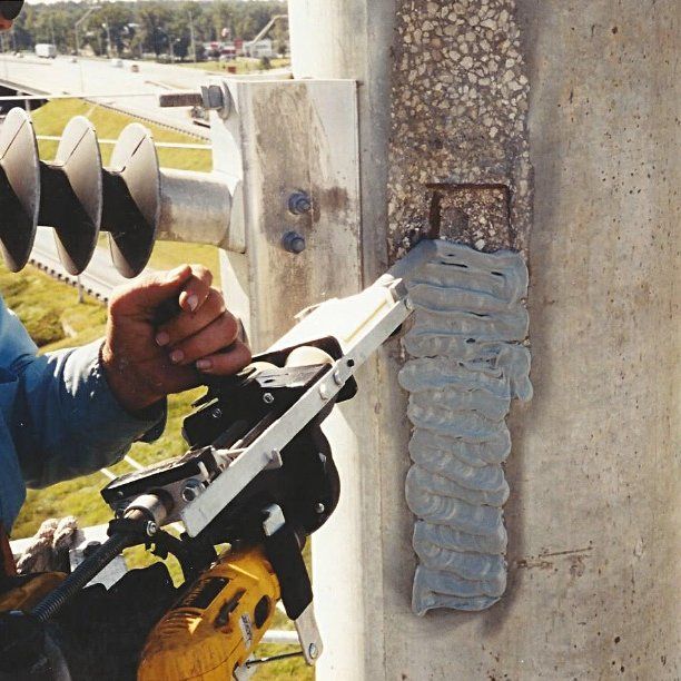 Concrete Pole Repair being applied to repair and strengthen a damaged utility pole