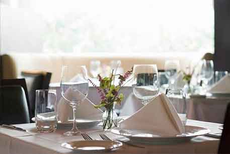 White Table With Arrangement — Restaurant Linen in Detroit, MI White Table With Arrangement — Restaurant Linen in Detroit, MI