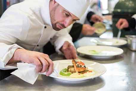 Chef Preparing Food — Restaurant Linen in Detroit, MI Chef Preparing Food — Restaurant Linen in Detroit, MI