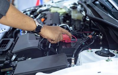 Car Inspections — Car Mechanic Working In Battery Check in Kennett Square, PA Car Inspections — Car Mechanic Working In Battery Check in Kennett Square, PA