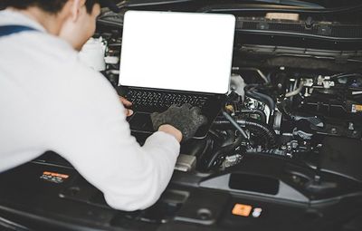 Classic Car Repair — Mechanic Checking The Car Thru The Laptop in Kennett Square, PA