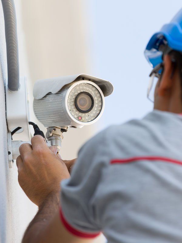 man installing survailance camera