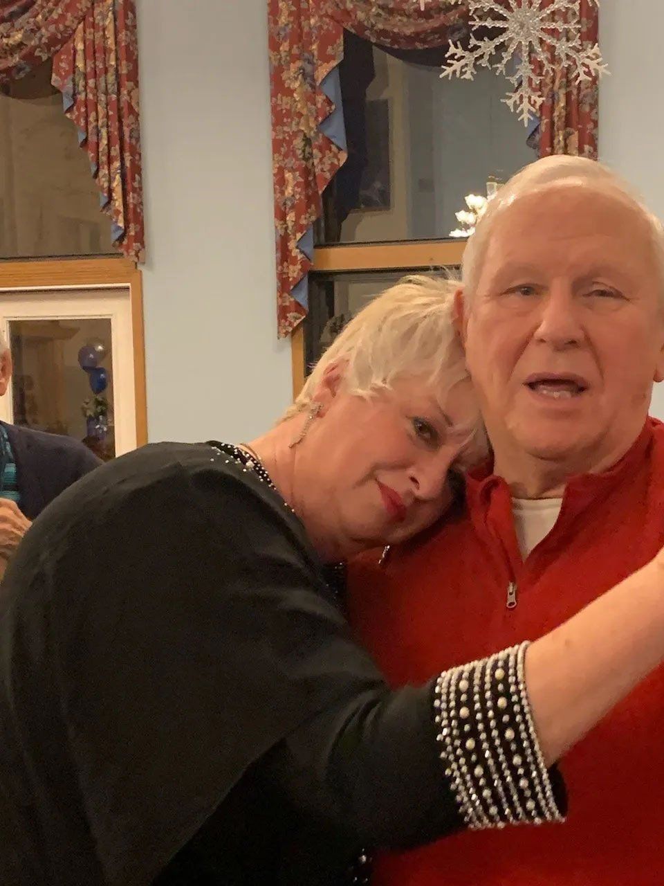 Happy Senior Couple Cuddling at Christmas Time