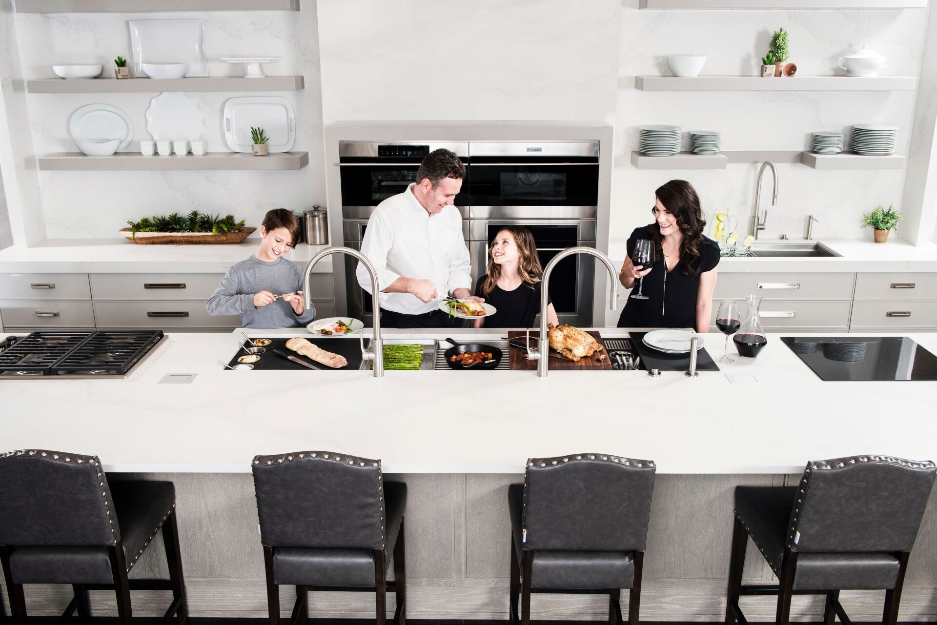 A family is preparing food in a kitchen.