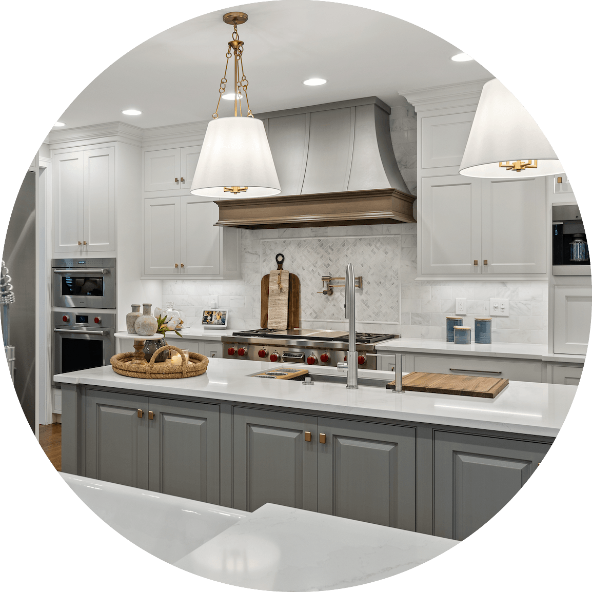A kitchen with gray cabinets and white counter tops in a circle.
