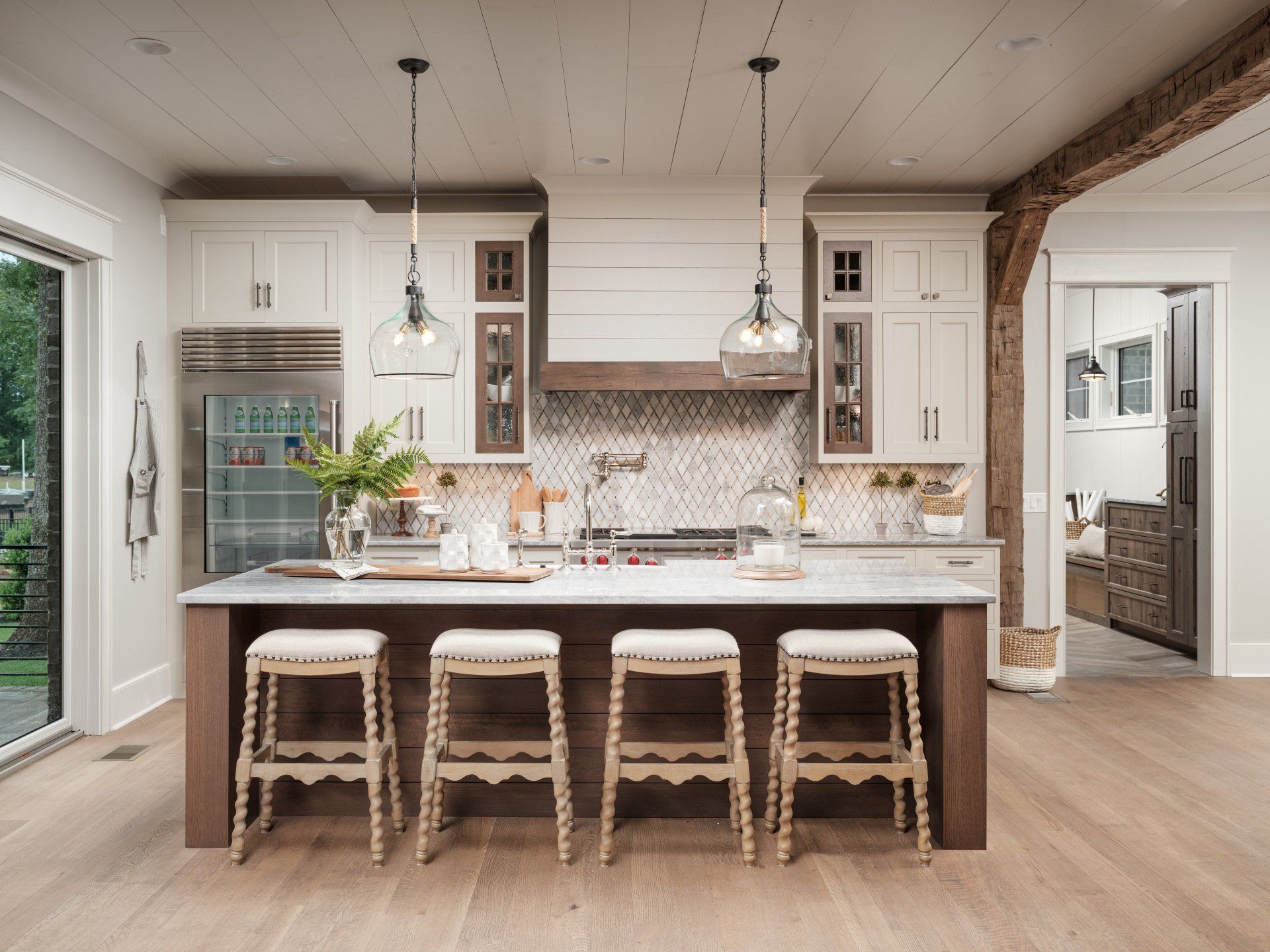 A kitchen with a large island and stools