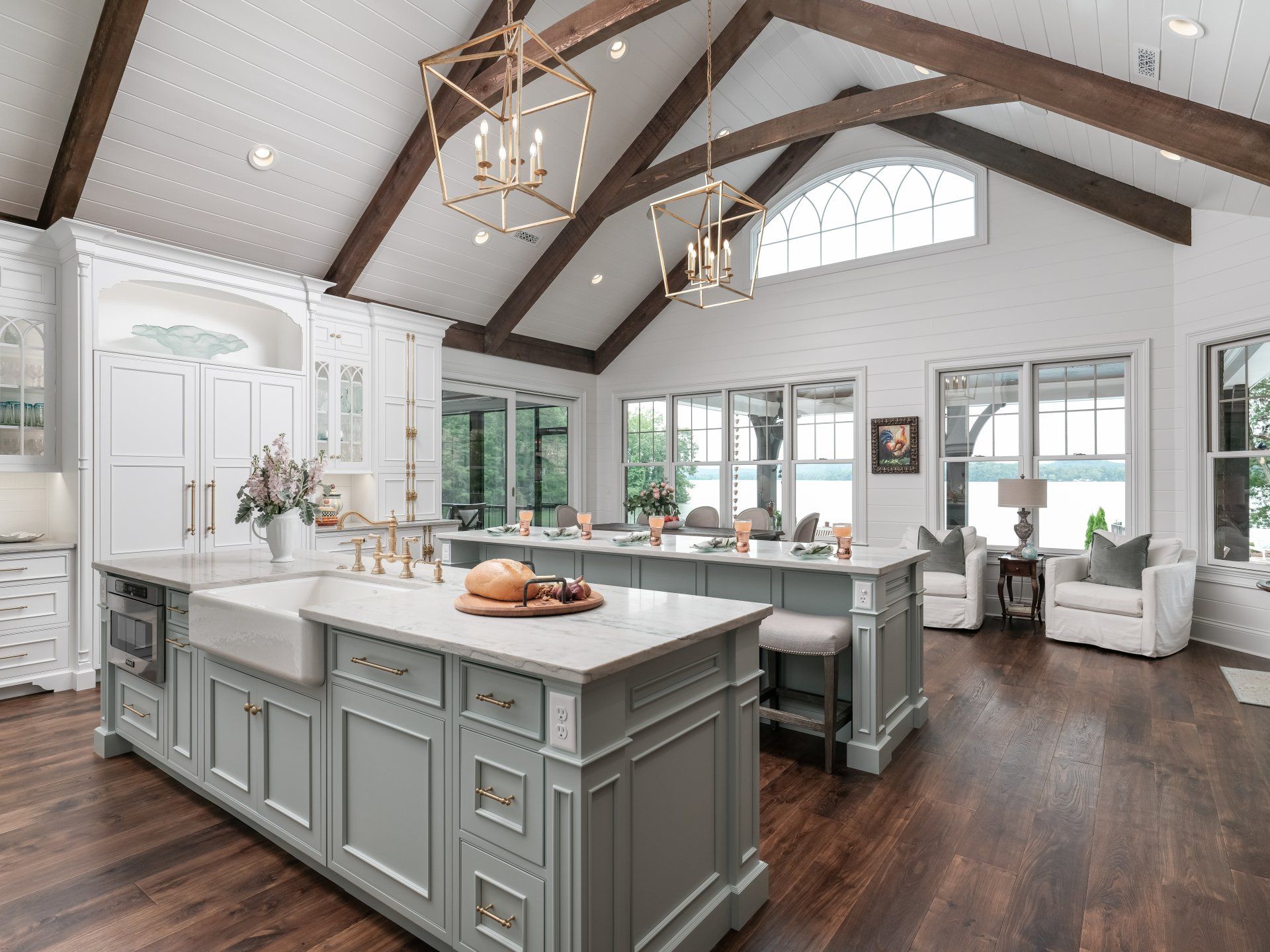 A large kitchen with a large island in the middle and a vaulted ceiling.
