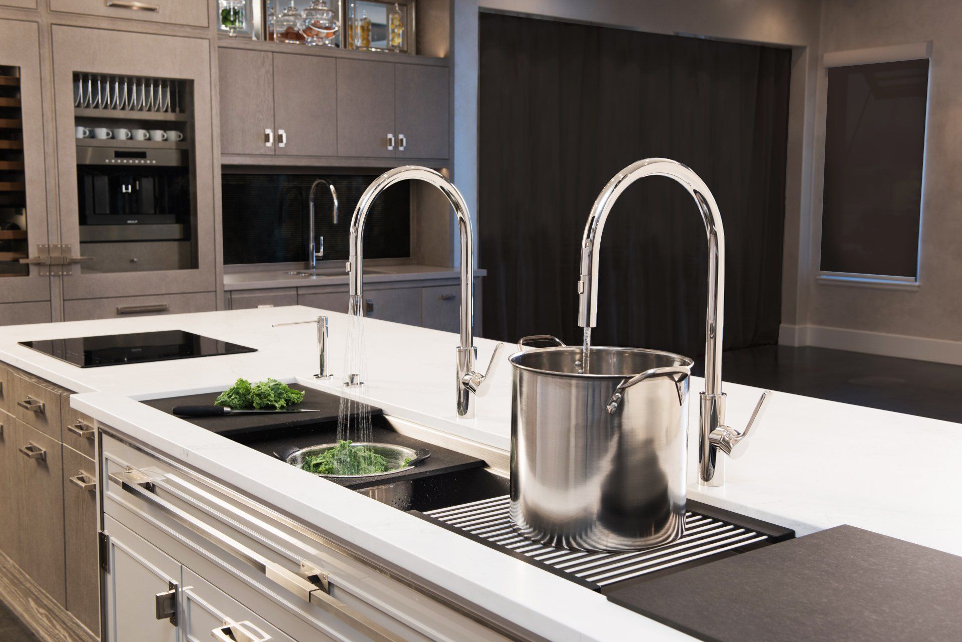 A kitchen with two sinks and a pot on the counter