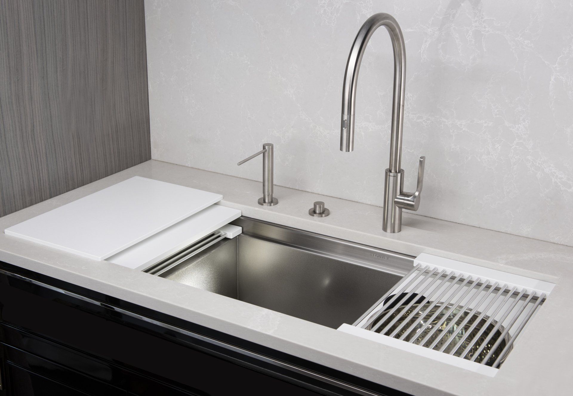 A kitchen sink with a faucet and a cutting board on top of it.