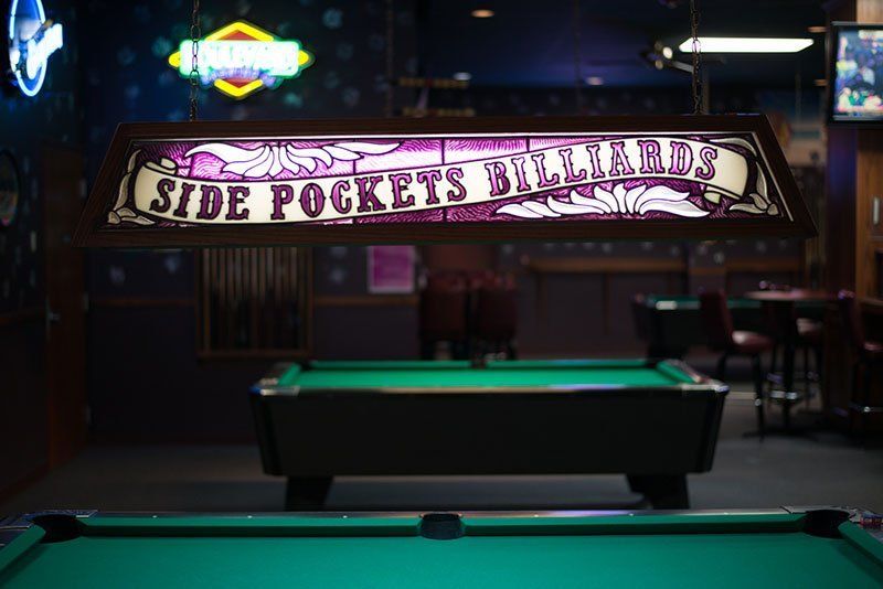 Pool tableunder a sign reading 