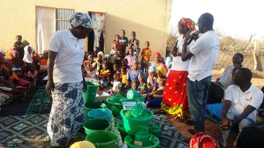 man speaking to villagers 