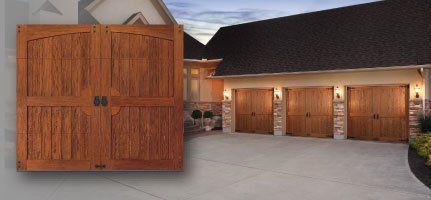 Wooden garage doors on a house with a concrete driveway and blue sky.