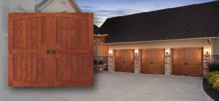 Wooden garage doors on a house with a concrete driveway.